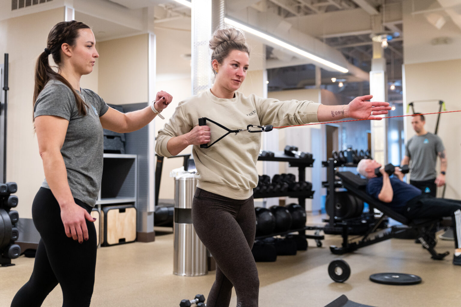 An Active Life coach guiding a client through a banded exercise